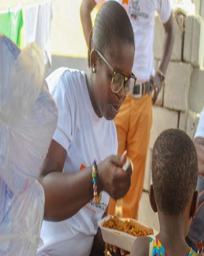Soar_africa_foundation_member_spoon_feeding_an_orphan